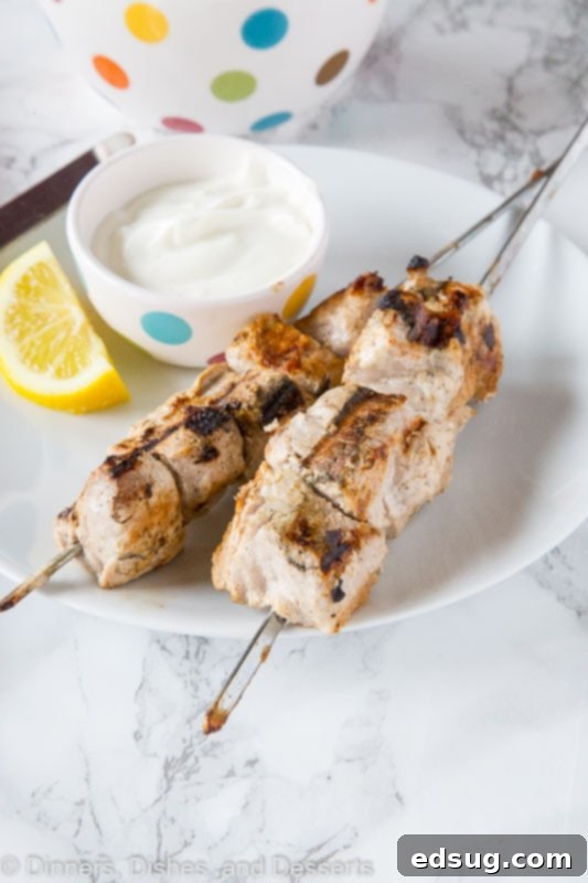 Tender Yogurt-Marinated Pork Kebabs 4 A plate of food with a fork, with Yogurt and Pork