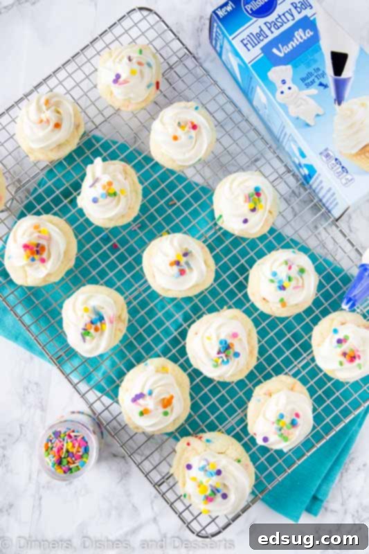 Sparkle-Topped Funfetti Cake Mix Cookies 3 A batch of cheerful Funfetti cake mix cookies, freshly baked and unfrosted, arranged neatly on a cooling rack, showcasing their vibrant sprinkle-filled interior before frosting.