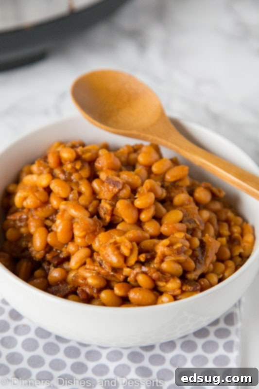 Hearty Homemade Baked Beans 4 A bowl of food on a plate, with Bean and Baked beans