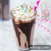 Chocolate Milkshake Recipe - the best way to cool off this summer with a homemade chocolate milkshake topped with whipped cream and sprinkles!