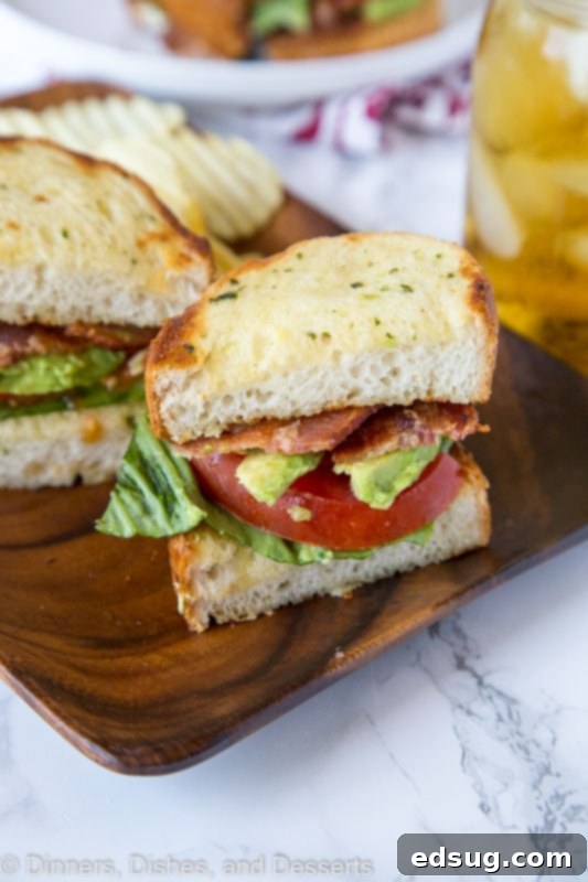 Ultimate Garlic Bread BLT 3 A sandwich cut in half on a plate, with Bread and BLT