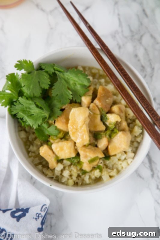 Large serving of Thai green curry chicken in a bowl, ready to eat