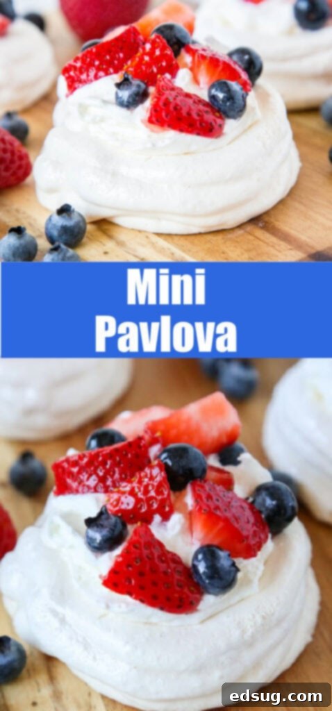 Easy Mini Pavlova Recipe 5 A selection of mini pavlovas topped with a generous amount of mixed berries, ready to be served on a wooden board.