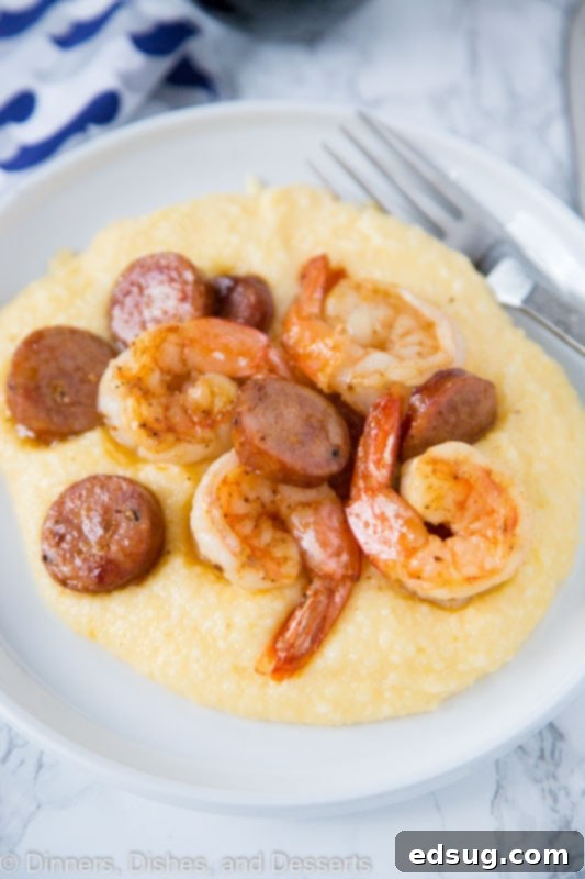Simple Shrimp and Grits 4 Close-up of a serving of shrimp and grits on a white plate, highlighting the textures.
