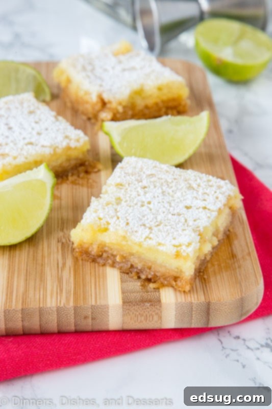 Zesty Lime Margarita Bars 2 sliced margarita bars on a cutting board
