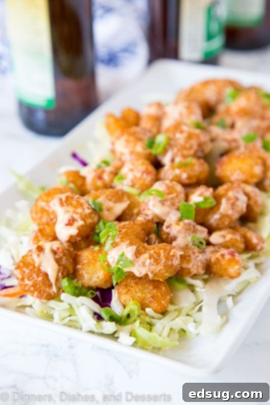 Crispy Bang Bang Shrimp with Sweet Chili Sauce 5 A vibrant plate of crispy Bang Bang Shrimp with sauce and a side of Asian coleslaw.
