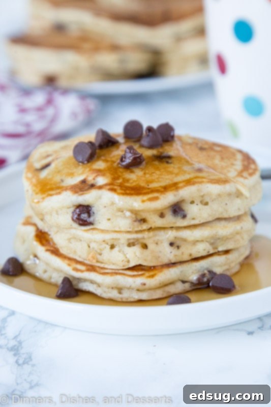 Stacked banana pancakes with chocolate chips on a plate, ready to be served