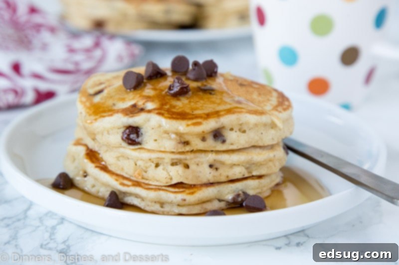 A fresh stack of chocolate chip banana pancakes on a plate, ready for syrup.