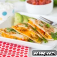 Chicken Fajita Quesadilla Supreme 6 quesadilla on a plate with Chicken and Fajita