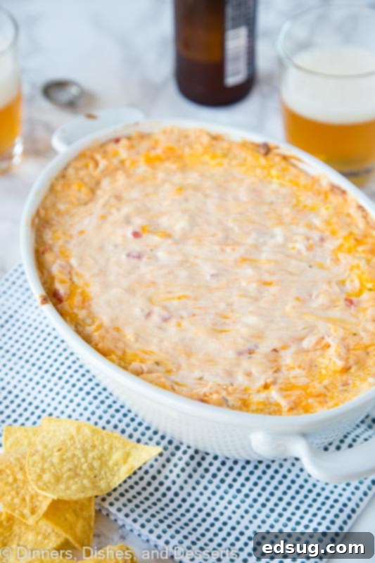 Cheesy Mexican Fiesta Dip 2 Baked cheese dip in a dish with tortilla chips, ready to serve