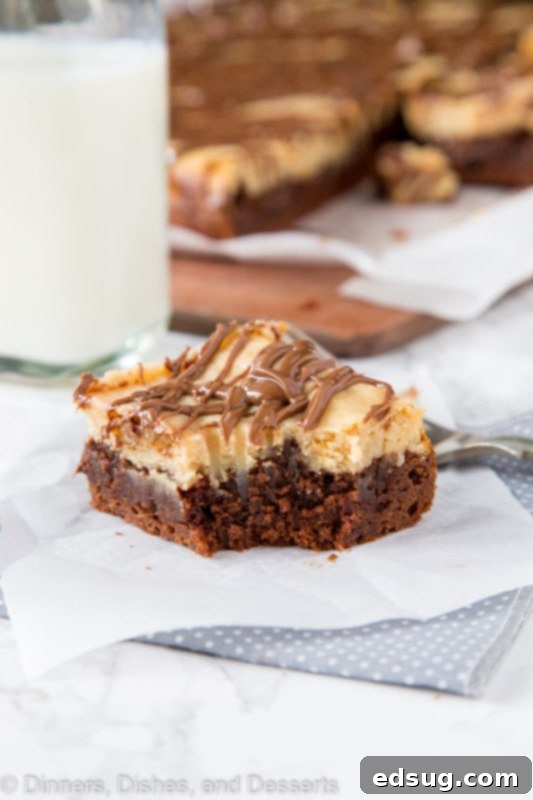 Decadent Peanut Butter Cheesecake Brownies 2 Peanut butter cheesecake brownie on a table with bit missing