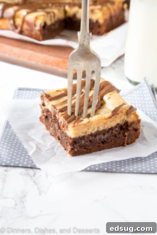 Decadent Peanut Butter Cheesecake Brownies 3 Peanut butter cheesecake brownie on a plate with a fork