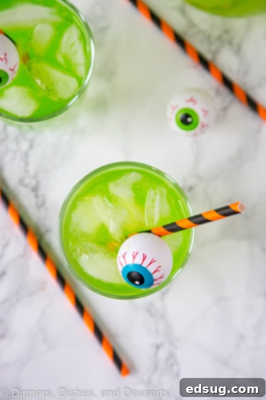 A cup of green Hawaiian punch with plastic eyeball for Halloween