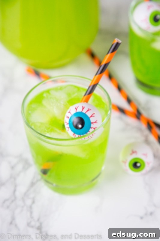 A cup of green Hawaiian punch with plastic eyeball for Halloween