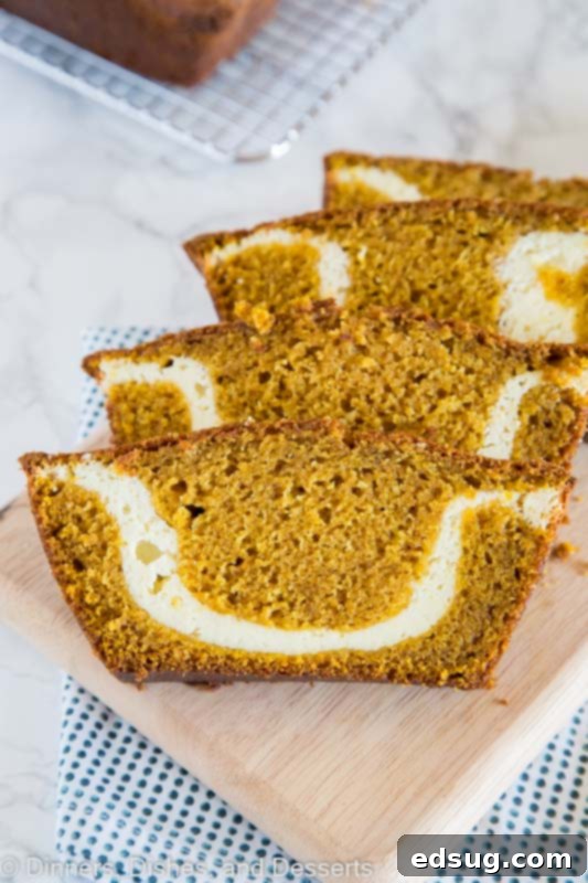 A slice of pumpkin bread with cream cheese swirl