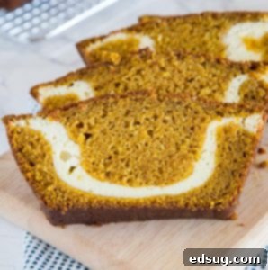 A slice of pumpkin bread with cream cheese swirl