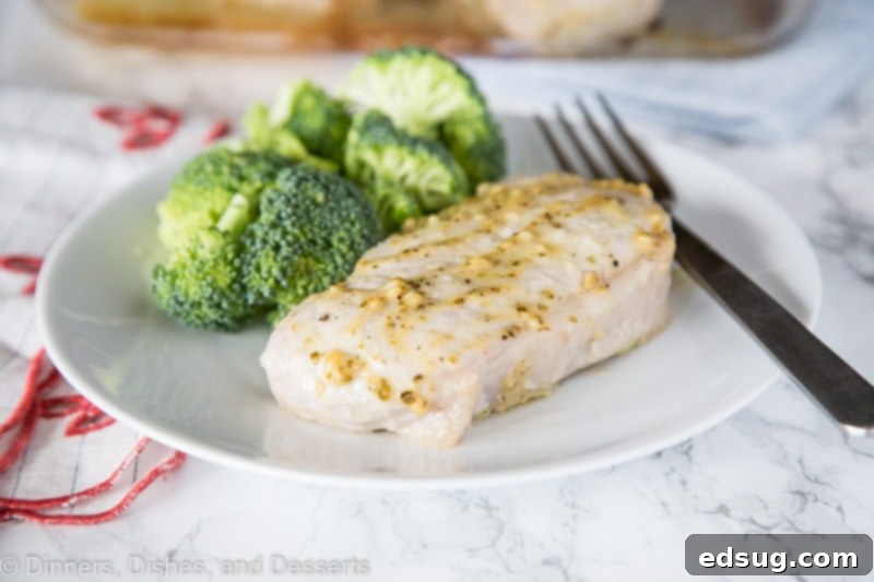 A plate of food with broccoli, with Pork and Pork chop