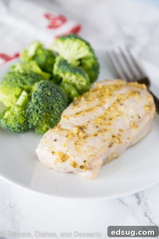 A plate of food with broccoli, with Pork and Pork chop