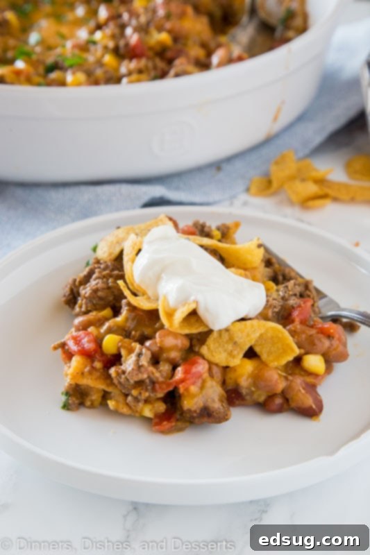 Classic Frito Pie Recipe 3 A colorful Frito Pie casserole on a table, highlighting the melted cheese and hearty filling.