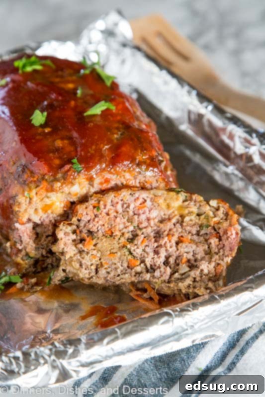 A close up of a piece of cake on a paper plate, with Meatloaf and Dinner