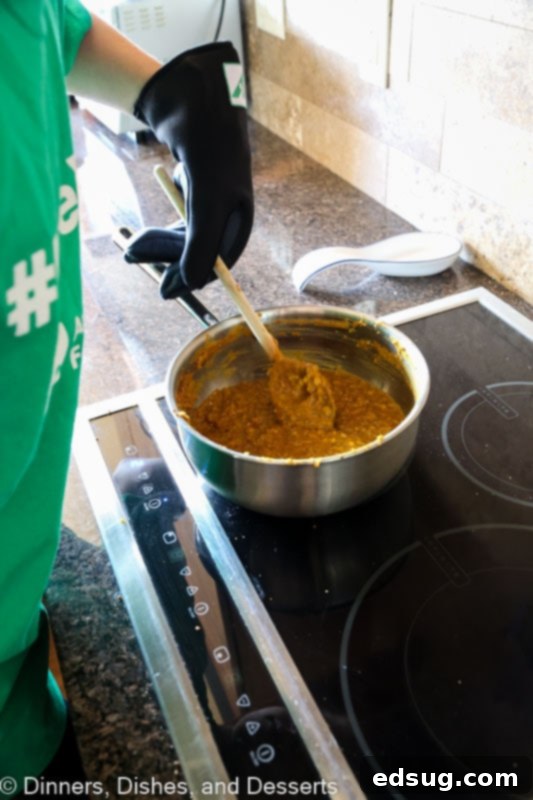 Aromatic Indian Daal 3 Indian Masoor Dal simmering in a pot, showcasing its rich red lentil base and aromatic spices.