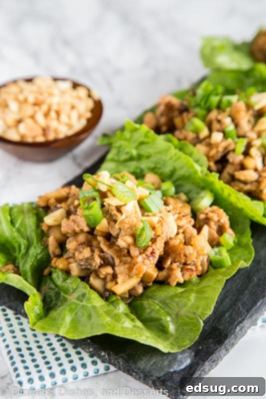 Savory Chicken Lettuce Cups 5 A plate of food with lettuce cups filled with chicken