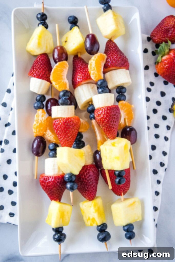 Colorful Fruit Skewers 5 fruit skewers on a white platter
