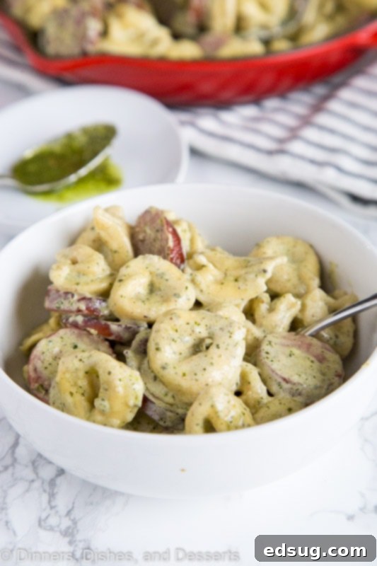 Luscious Pesto Tortellini 4 A close-up shot of creamy pesto pasta in a rustic bowl, highlighting the rich sauce and tortellini.