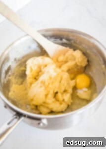 Sweet Homemade Churro Delights 11 second egg being stirred into dough