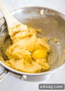 Sweet Homemade Churro Delights 12 third egg being stirred into dough