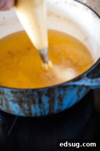 Sweet Homemade Churro Delights 15 piping batter into hot oil