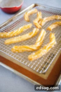 Sweet Homemade Churro Delights 18 churros on a cooling rack