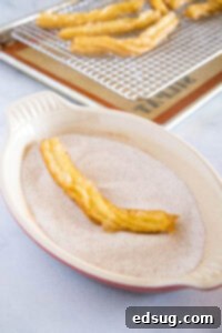 Sweet Homemade Churro Delights 19 fried churro being tossed in cinnamon sugar