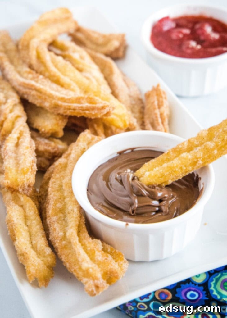 Sweet Homemade Churro Delights 3 homemade churro being dipped in chocolate sauce