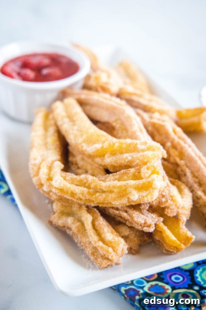 Sweet Homemade Churro Delights 7 churros on a plate with strawberry dipping sauce