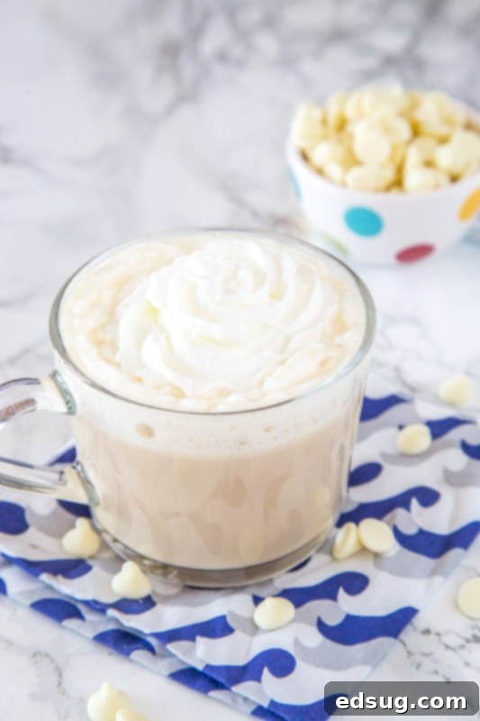 Fireside White Chocolate Mocha 2 A beautifully presented cup of Toasted White Chocolate Mocha, rich and inviting, on a table.