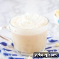 Fireside White Chocolate Mocha 5 A cup of Toasted White Chocolate Mocha with chocolate shavings on top, served warm.