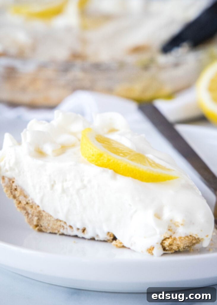 creamy lemonade pie on a white plate with lemon slices