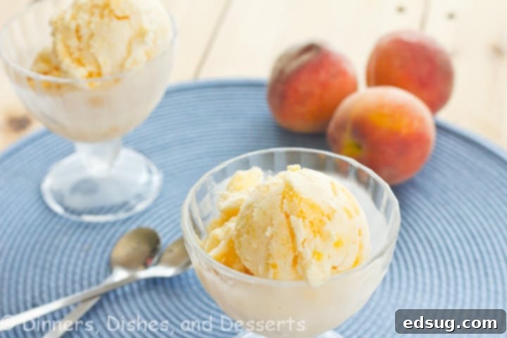 Close-up shot of the creamy vanilla peach swirl frozen yogurt in a cup, showing the vibrant peach streaks