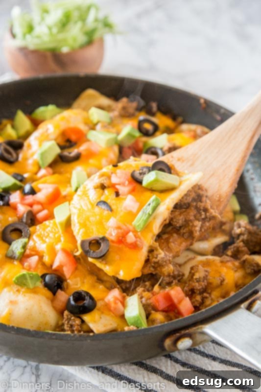 Loaded Pierogy Taco Skillet 2 A pan filled with food, with Taco and Pierogi