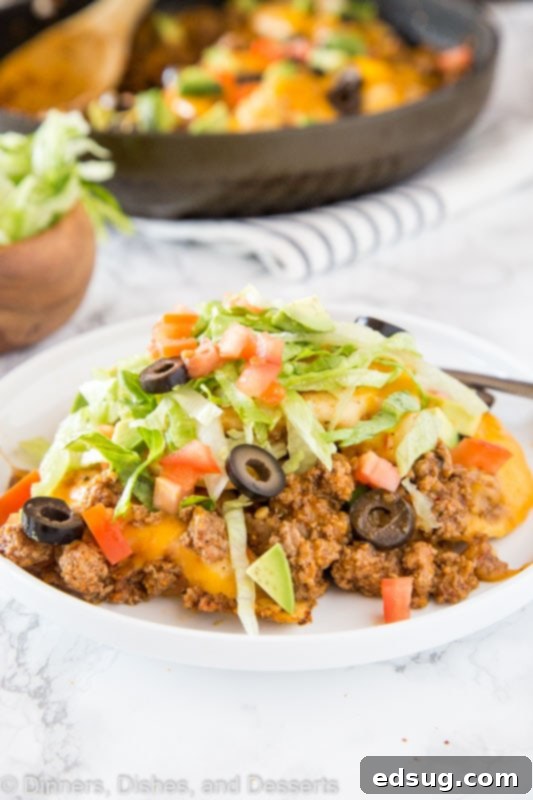 Loaded Pierogy Taco Skillet 3 A plate of food on a table, with Taco and Pierogi