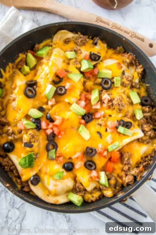 Loaded Pierogy Taco Skillet 4 A pan of food on a plate, with Taco and Pierogi