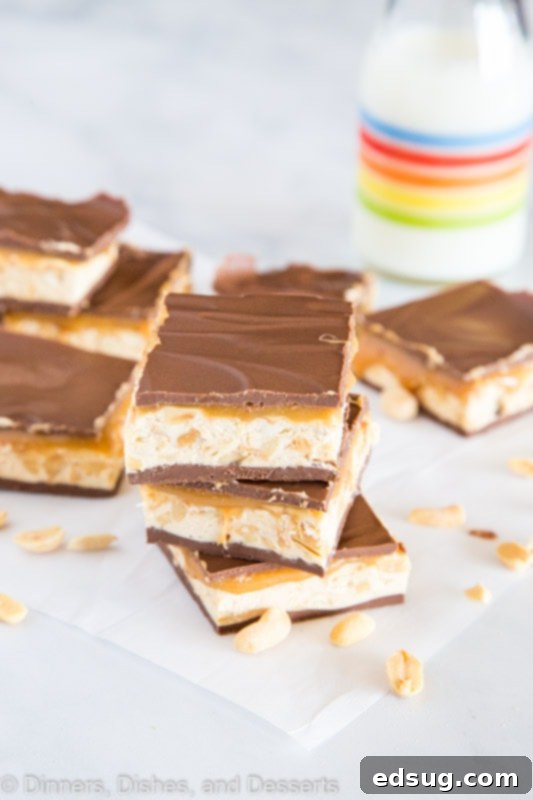 Decadent Chocolate Caramel Nougat Bars 4 chocolate caramel nougat bars stacked on a table, with Nougat and Peanut