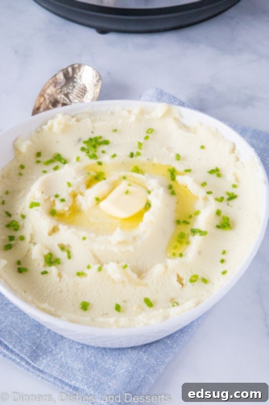 Creamy Instant Pot Mashed Potatoes 7 A bowl of mashed potatoes with butter and chives
