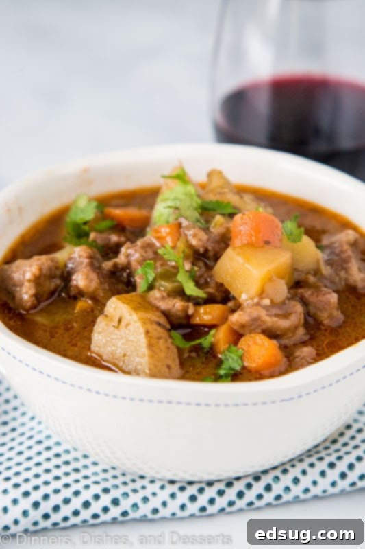 Hearty Instant Pot Beef Stew 4 A bowl of food on a plate, with Stew and Beef