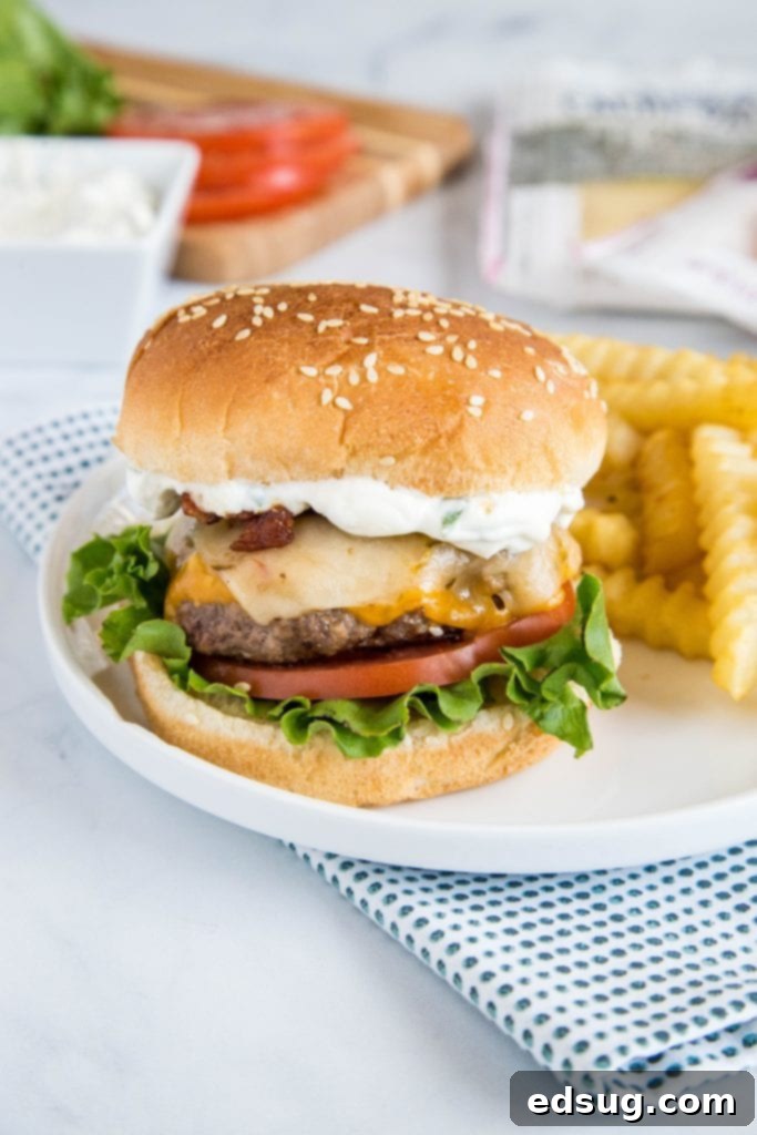 Spicy bacon cheeseburger plated with sauce