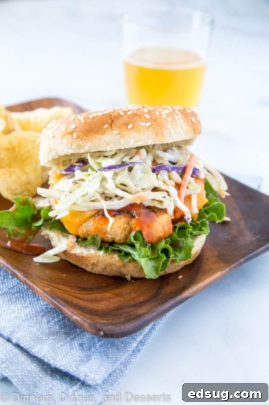 Buffalo Chicken Burger served on a rustic wooden plate, ready to be enjoyed.