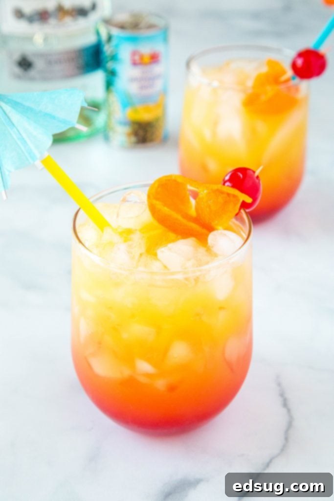 Mai Tai Bliss 2 Mai Tai with umbrella straw, garnished with a lime wedge and cherry, on a tropical background.