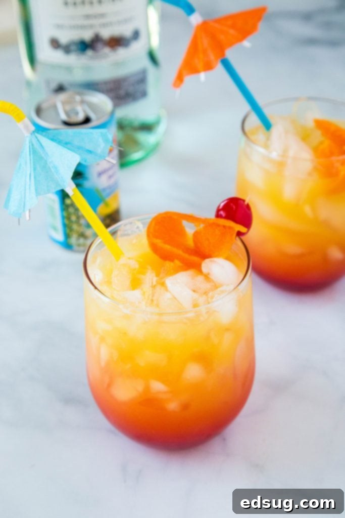 Mai Tai Bliss 3 Two vibrant Mai Tai drinks, garnished with orange slices and cherries, ready to be served.