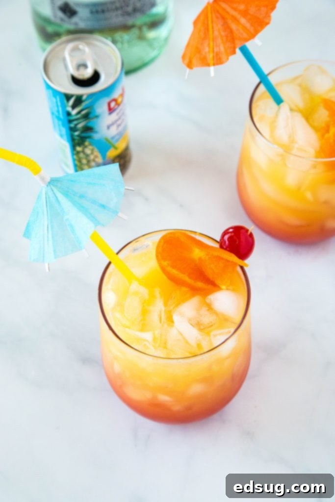 Mai Tai Bliss 4 Close-up aerial view of a Mai Tai drink, garnished with an orange slice and cherry.